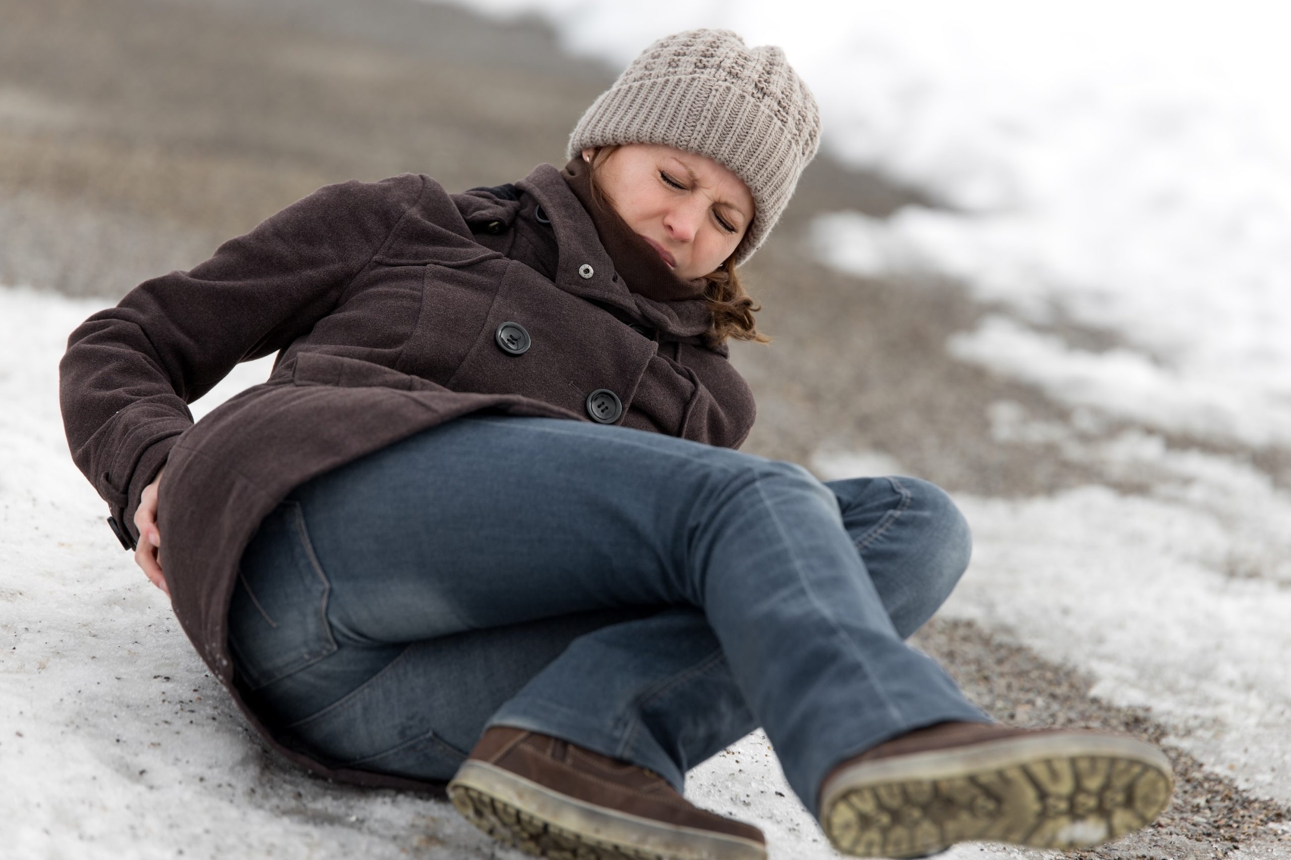 Young woman has an accident on an icy walkway in Michigan.